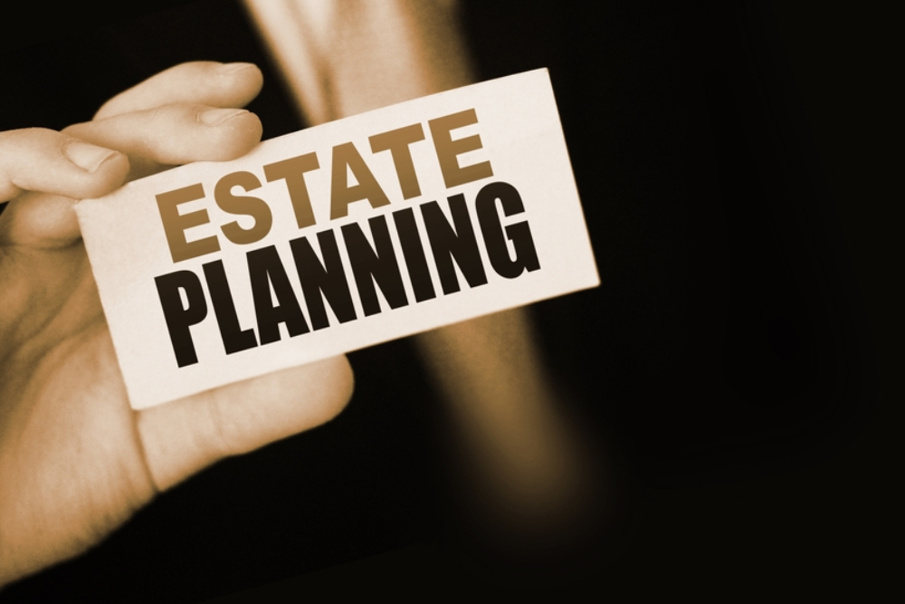 estate Planning words on card a businessman shows