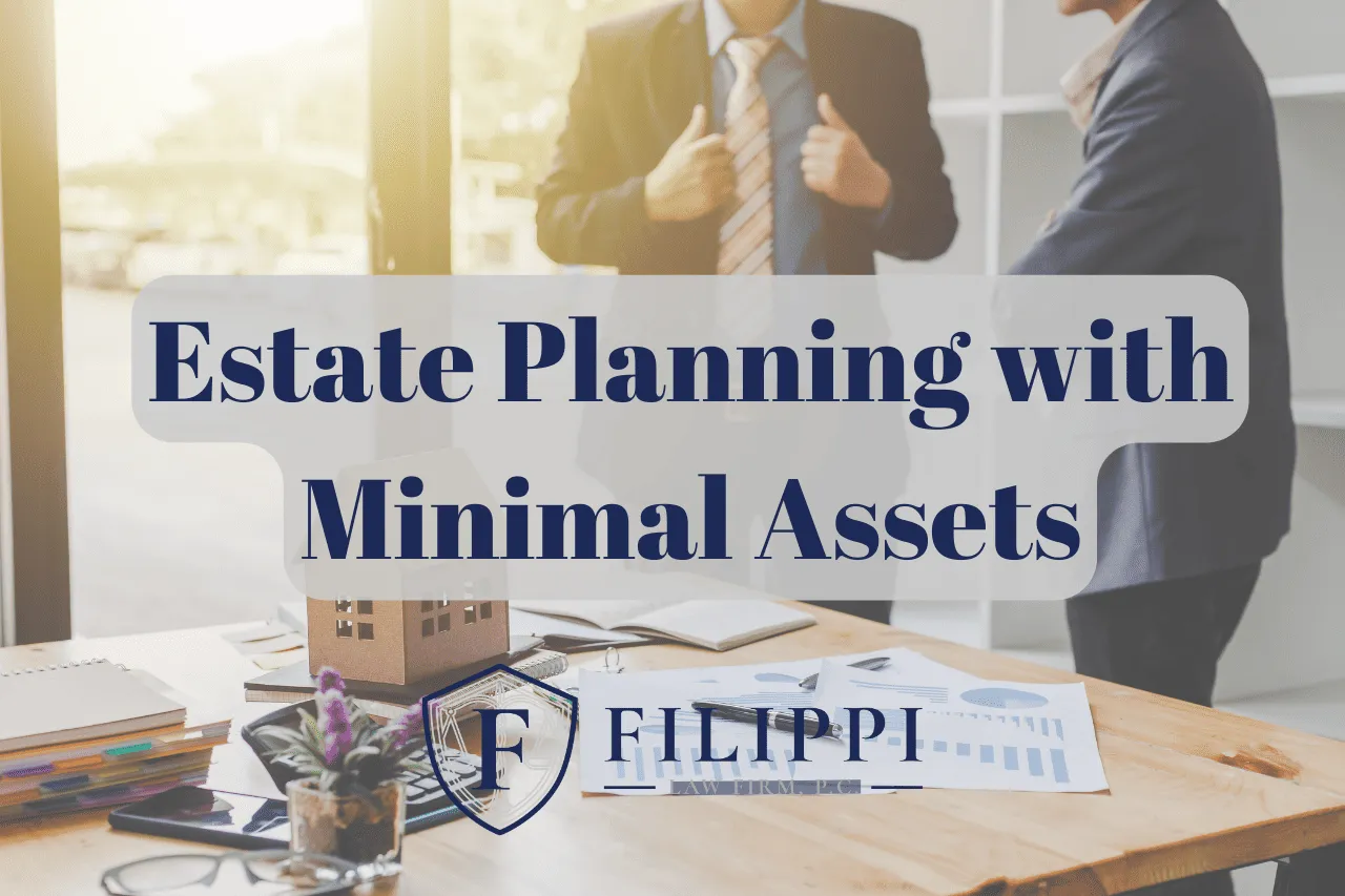 Two business professionals conversing near a wooden desk with documents, a model house, and a plant, overlaid with text "Estate Planning with Minimal Assets" and the logo "Filippi Law Firm P.C.