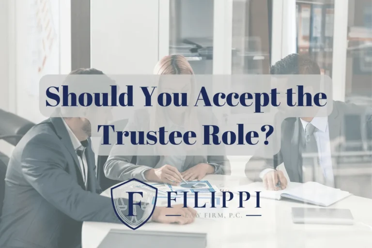 Three business professionals in formal attire seated around a table with text overlay: "Should You Accept the Trustee Role?" and the logo of Filippi Law Firm, P.C.