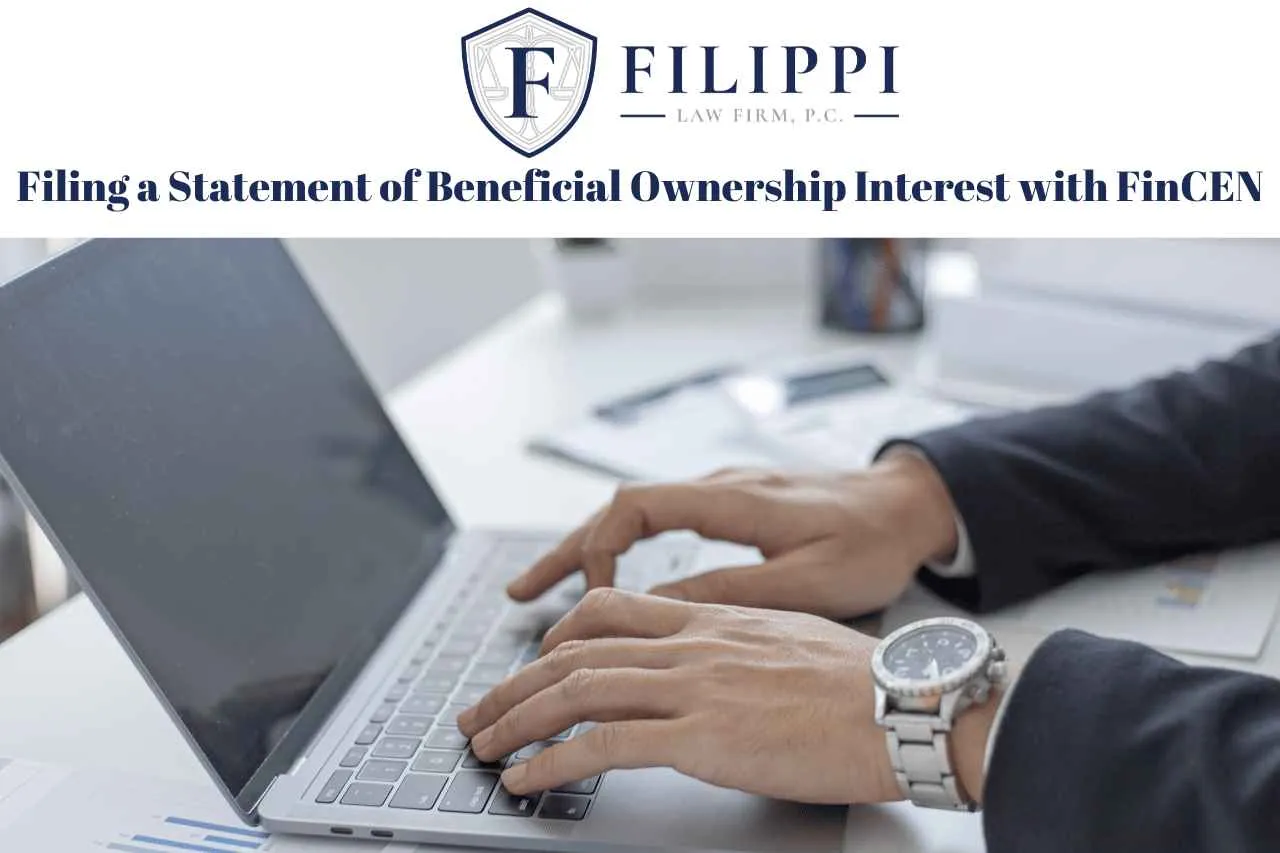 Person typing on a laptop with Filippi Law Firm logo and text about filing beneficial ownership interest.