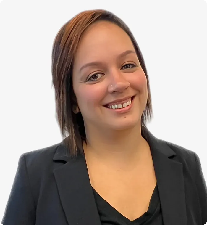 Professional portrait of a smiling woman with short brown hair wearing a black blazer.