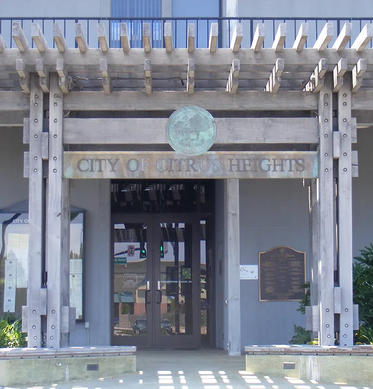 Entrance to the City of Citrus Heights building with wooden pergola and glass double doors.
