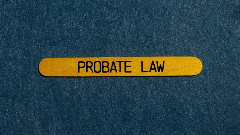 Yellow wooden stick with the text "PROBATE LAW" on a dark textured background.
