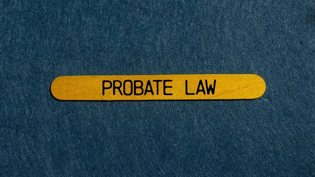 Yellow wooden stick with the text "PROBATE LAW" on a dark textured background.