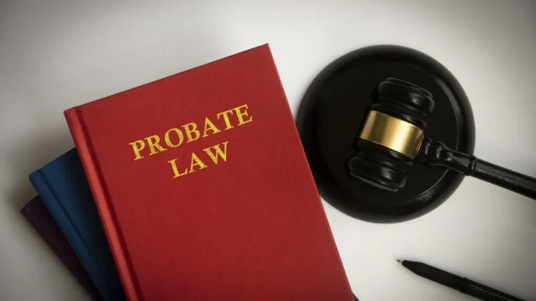 Red hardcover book titled "Probate Law" next to a black judge's gavel and pen.